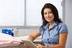 Happy nurse doctor reading over patient notes